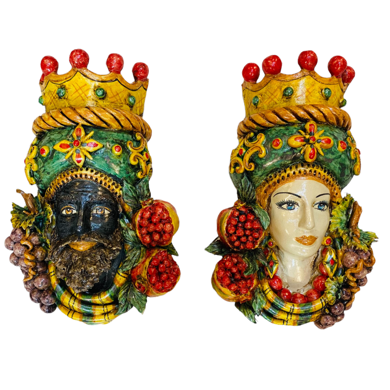 Pair of wall hanging Moor's heads, Caltagirone, with crown and fruit, verdigris background, opaque enamel, height about 