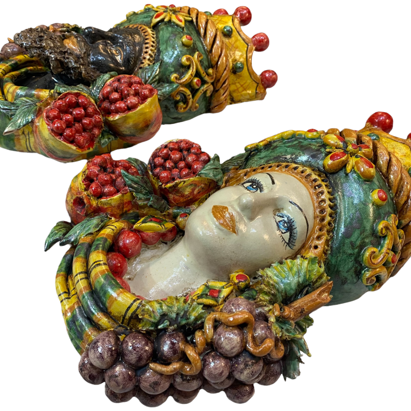 Pair of wall hanging Moor's heads, Caltagirone, with crown and fruit, verdigris background, opaque enamel, height about 