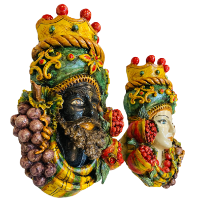 Pair of wall hanging Moor's heads, Caltagirone, with crown and fruit, verdigris background, opaque enamel, height about 