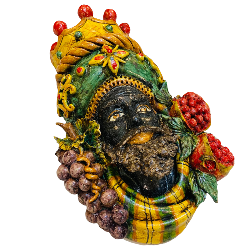 Pair of wall hanging Moor's heads, Caltagirone, with crown and fruit, verdigris background, opaque enamel, height about 