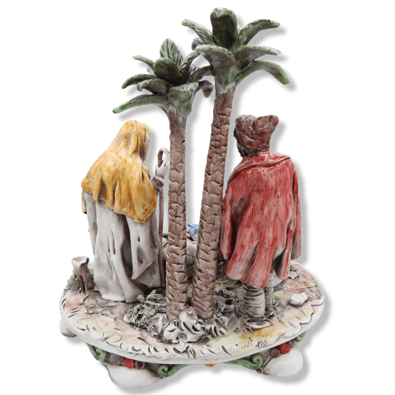 Large ceramic Nativity scene from Caltagirone, Holy Family with bagpiper and palm trees on a baroque base, approx. 37 x 