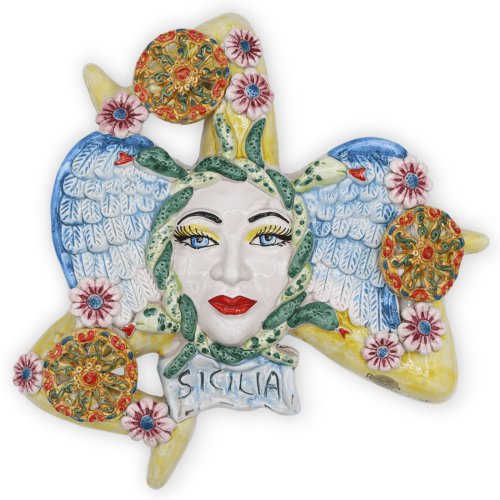 Trinacria in Caltagirone ceramic, with applications of cart wheels and flowers, h 38 cm approx. RP mod -