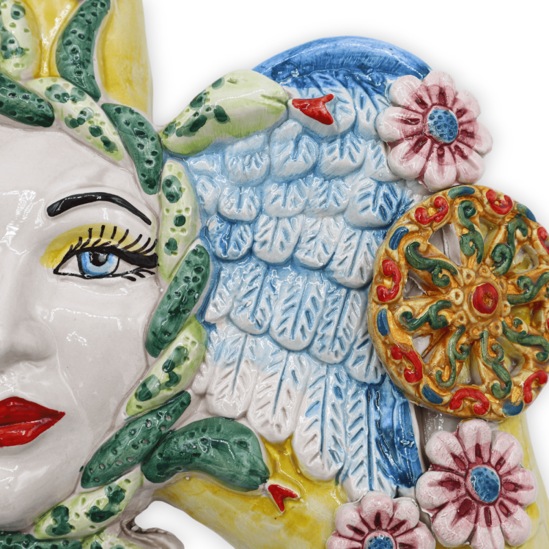 Trinacria in Caltagirone ceramic, with applications of cart wheels and flowers, h 38 cm approx. RP mod - 
