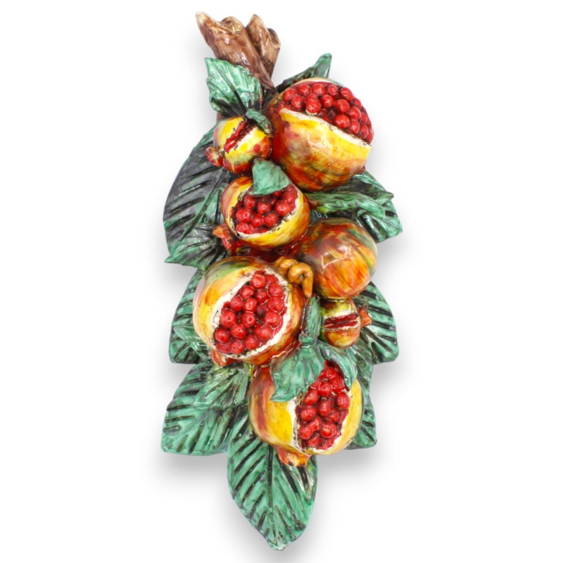 Hanging bundle of pomegranates, in...