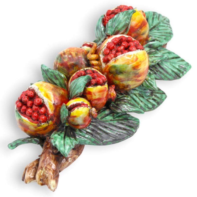 Hanging bundle of pomegranates, in...
