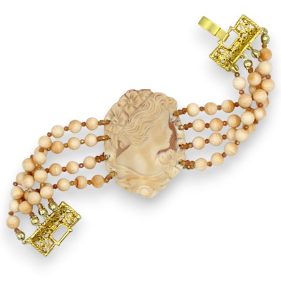Handcrafted bracelet with three strands of carnelian beads, pink cameo, length approx. 20 cm. Brass base.
